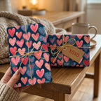 Romantic pink heart gift wrap on navy blue Valentine's Day presents by Wrapped Studios.