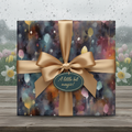 Elegant birthday wrapping paper featuring a watercolor floral pattern and gold ribbon.