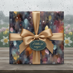 Elegant birthday wrapping paper featuring a watercolor floral pattern and gold ribbon.