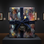 Elegant square gift wrapped in watercolor floral wrapping paper with navy velvet ribbon and bow.