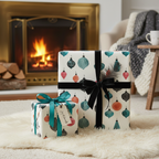 Elegant Christmas gift wrap with a festive ornament pattern, black velvet ribbon, and teal bow on a cozy white rug by a fireplace.