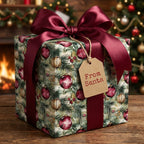 Christmas gift wrapped in festive ornament paper with a burgundy ribbon bow and "From Santa" tag.