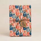 Cute woodland owl wrapping paper by Wrapped Studios in pink and blue, tied with a rustic twine bow.
