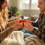 Couple exchanging a gift in cute peach wrapping paper with a velvet ribbon, by Wrapped Studios.