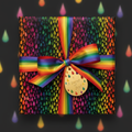 Rainbow ribbon on a gift box wrapped in colorful teardrop pattern paper with a "burst of joy" tag.