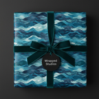 Blue wave pattern wrapping paper with dark green velvet ribbon and tag.