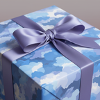 Close-up of a wrapped gift with abstract blue wrapping paper and a lilac ribbon, perfect for birthday or baby shower gifts.
