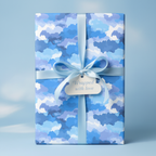 Blue watercolor wrapping paper with ribbon and gift tag, perfect for baby shower gifts.