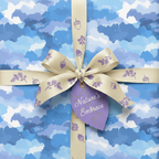 Sky blue watercolor gift wrap with acorn-print ribbon and leaf tag, "Nature's Embrace."