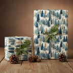 Elegant Christmas gift wrap featuring a blue and beige winter forest pattern, tied with twine and green ribbons.