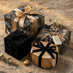 Wrapped Studios luxury gift wrap with floral, black, and gold patterns and velvet ribbons.