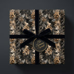 Elegant floral wrapping paper with pinecone and botanical print, tied with a black velvet ribbon.