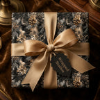 Elegant pinecone Christmas gift wrap by Wrapped Studios with gold ribbon on a square present.