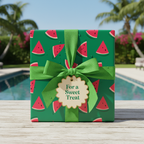 Summer-themed watermelon slice wrapping paper with green ribbon and a "For a Sweet Treat" tag, perfect for birthday or party gifts.