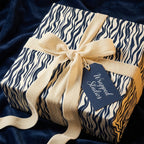 Navy and cream wave print wrapping paper with velvet ribbon from Wrapped Studios.