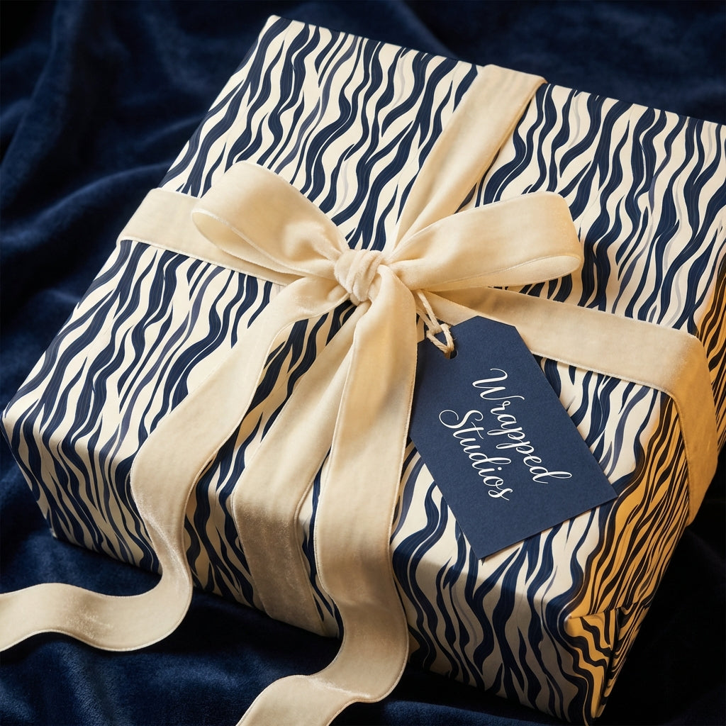 Navy and cream wave print wrapping paper with velvet ribbon from Wrapped Studios.