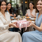 Woman passing a gift wrapped in floral wrapping paper with pink ribbon at a party.