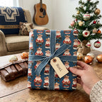Cowboy Santa Christmas wrapping paper with a denim bow on a rustic holiday table by Wrapped Studios.