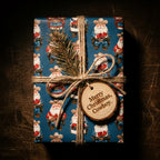 Cowboy Santa Christmas wrapping paper tied with rustic twine and wooden tag by Wrapped Studios.