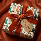 Western cowboy boot wrapping paper with a rust velvet bow and gift tag by Wrapped Studios.