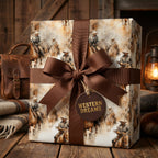 "Western Dreams" gift wrapped in cowboy-themed wrapping paper with a brown ribbon and rustic wooden background.