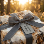 Western themed gift wrap with gray ribbon on a square box for birthdays or special occasions.