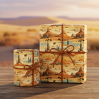 Gifts wrapped in tan Western-themed wrapping paper with cacti, mesas and horses, tied with brown rope on a wood surface.