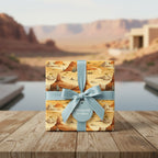 Desert landscape wrapping paper on a gift with a light blue ribbon.