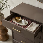 Dark floral wrapping paper used as a luxury drawer liner in a brown dresser, by Wrapped Studios.