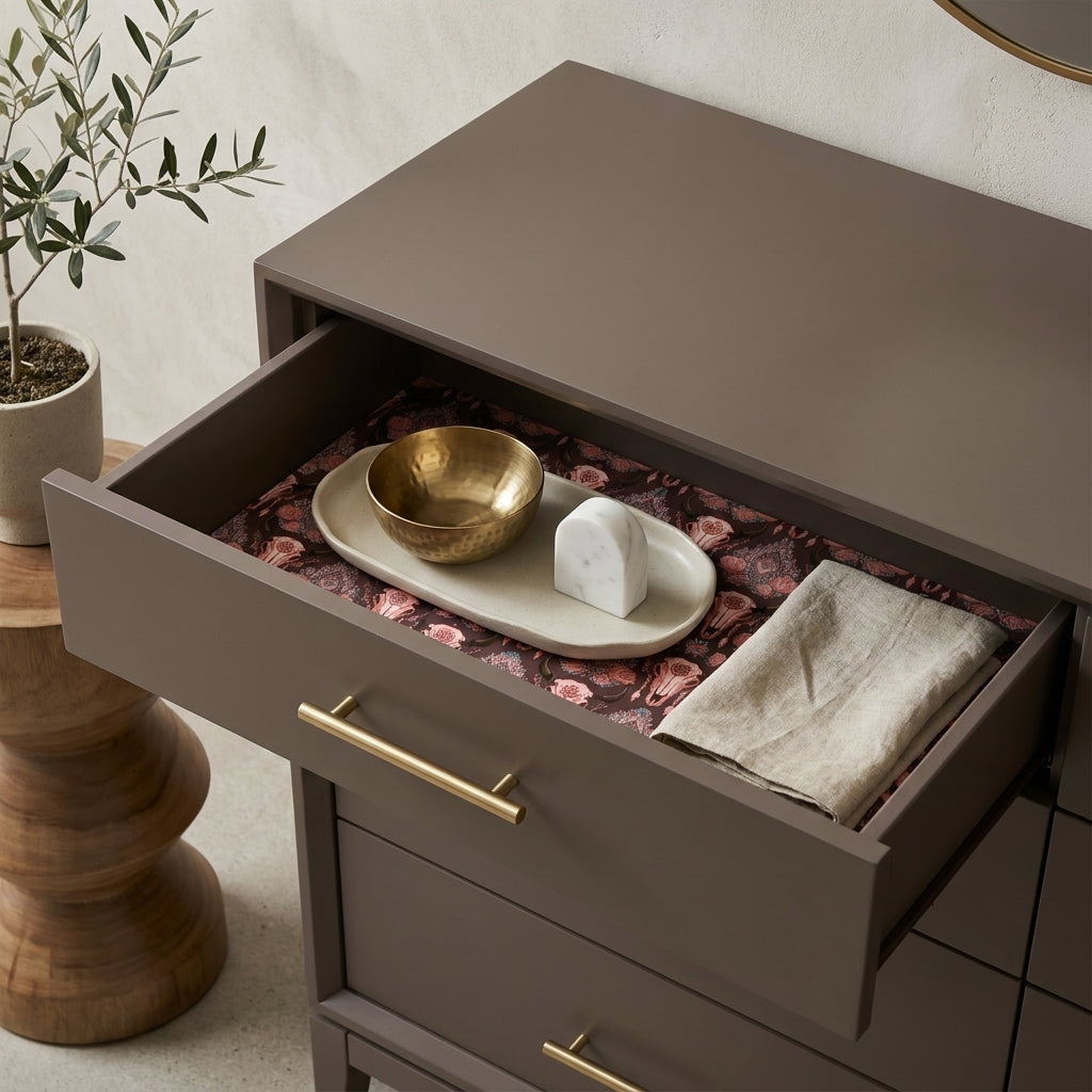 Dark floral wrapping paper used as a luxury drawer liner in a brown dresser, by Wrapped Studios.