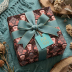 Rustic boho steer skull wrapping paper with a teal ribbon and gift tag by Wrapped Studios.