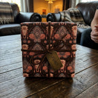 Boho western wrapping paper with bull skulls and roses, tied with a leather cord by Wrapped Studios.