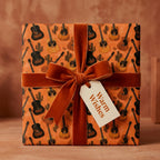 Acoustic guitar wrapping paper with a velvet bow, rustic music gift wrap by Wrapped Studios.