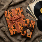 Acoustic guitar wrapping paper on rustic gifts next to vinyl records, by Wrapped Studios.