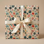 Wrapped gift in elegant floral wrapping paper with cream ribbon bow from Wrapped Studios.