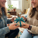 Two women exchanging a gift wrapped in floral wrapping paper with a teal velvet bow.