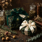 Wrapped Studios luxury gift wrap with a botanical pattern, velvet ribbons, and vintage-inspired styling.