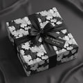 Elegant gift wrapped in black and white floral wrapping paper with a satin ribbon and "A Special Gift For You" tag.