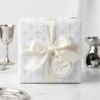 Religious baptism wrapping paper with grey cross pattern and ivory satin bow by Wrapped Studios.