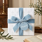 Christian cross baptism wrapping paper with blue velvet ribbon, elegant religious gift wrap by Wrapped Studios.