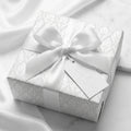 Elegant white damask wedding wrapping paper with satin bow on a luxury gift box by Wrapped Studios.