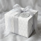 Luxury white damask wedding wrapping paper with a silver bow and tag by Wrapped Studios.