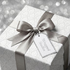 Elegant white and silver damask luxury gift wrap with satin ribbon bow by Wrapped Studios.