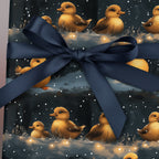 Gift wrapped in cute duckling themed baby shower wrapping paper with dark blue satin ribbon.