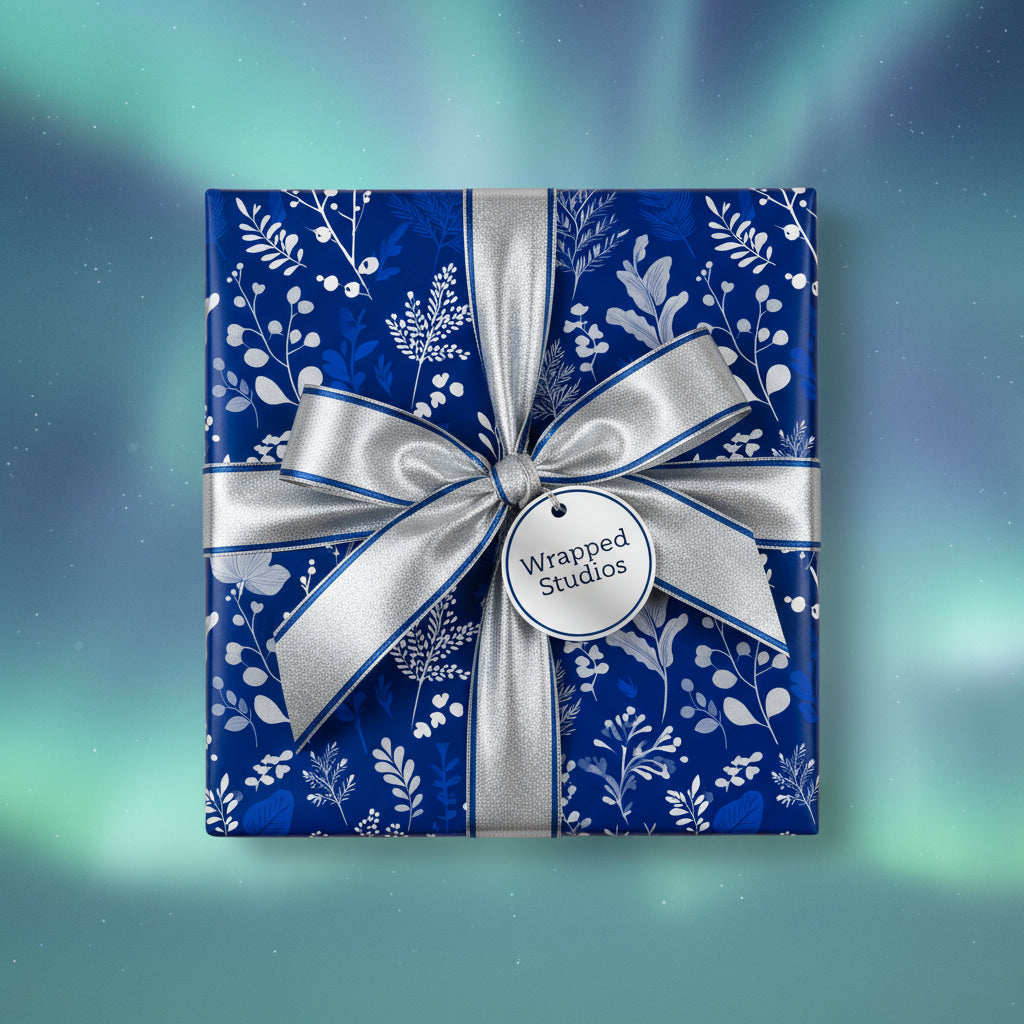 Elegant floral wrapping paper in deep blue with silver ribbon and bow.
