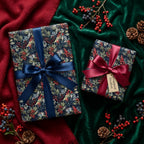 Luxury botanical Christmas wrapping paper with satin bows on holiday gifts by Wrapped Studios.
