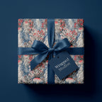 Whimsical mushroom and jellyfish wrapping paper with a navy blue ribbon bow by Wrapped Studios.