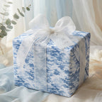 Elegant gift wrapped in blue abstract-patterned paper, adorned with a sheer white ribbon and "With Love" tag.
