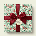Wrapped Studios festive floral gift wrap featuring red berries and a burgundy ribbon.
