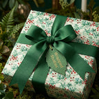 Wrapped Studios Christmas gift wrap: Floral pattern with green ribbon and leaf tag.